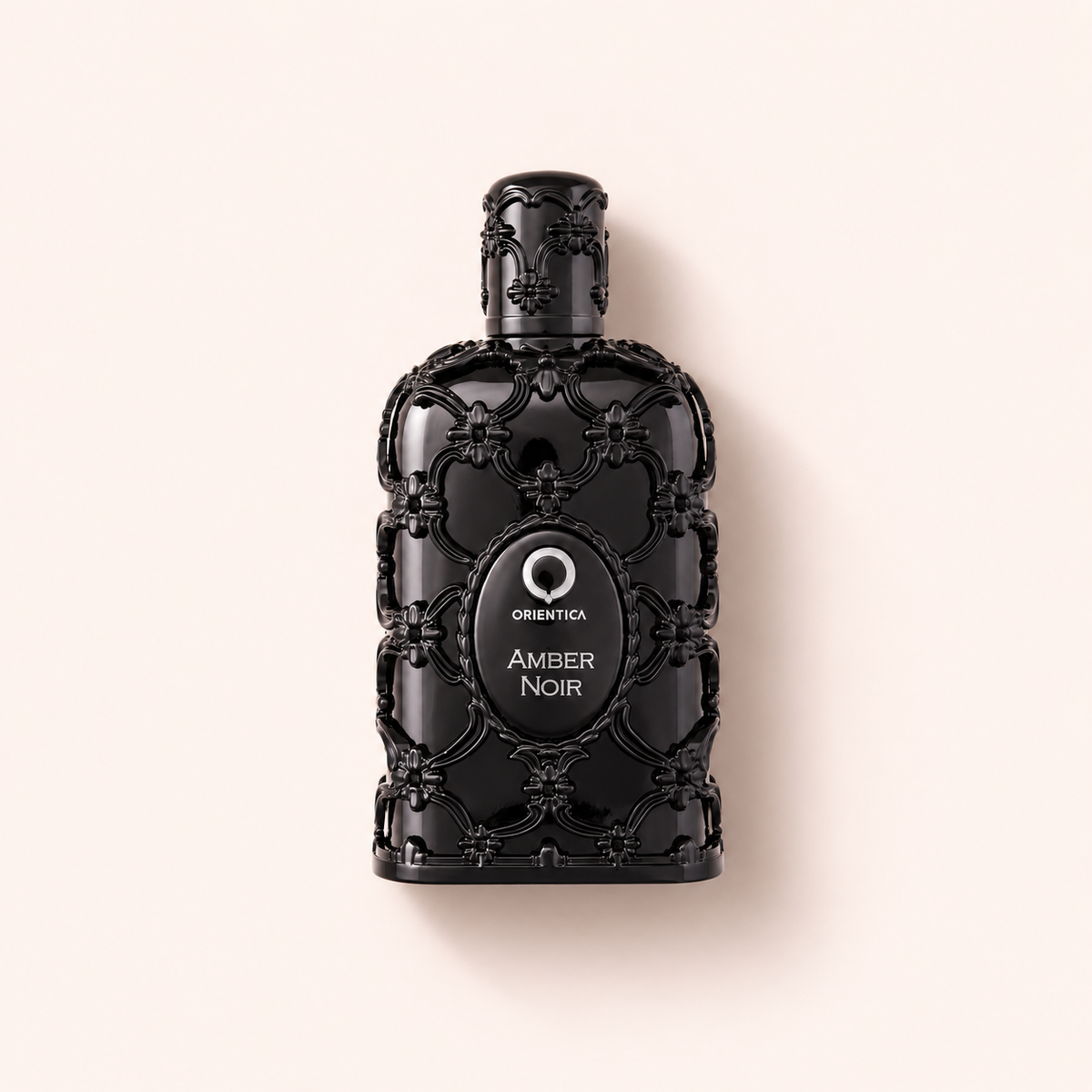 Orientica Luxury Collection Amber Noir EDP 150 ml na teplém růžovém pozadí – MrRizz